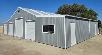 NBT Construction shed builder homepage image of a rural 4 door shed in a light green with white doors.