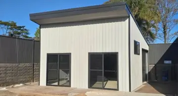NBT Construction shed builder homepage image of a Skillion shed in white, useful for a granny flat.